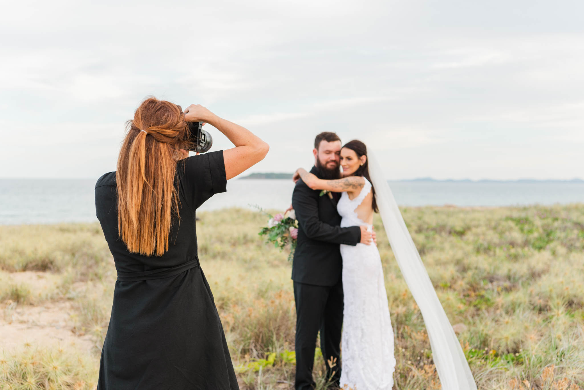Whitsunday photographer taking photos of bride and groom. 