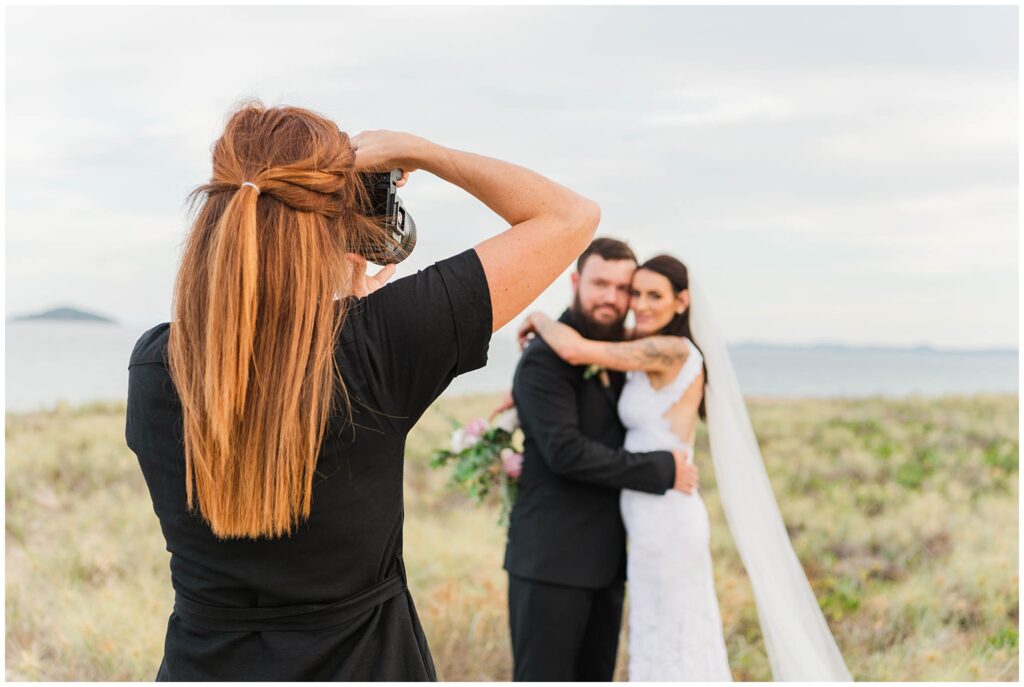 Alyce Holzy photographing a wedding couple.