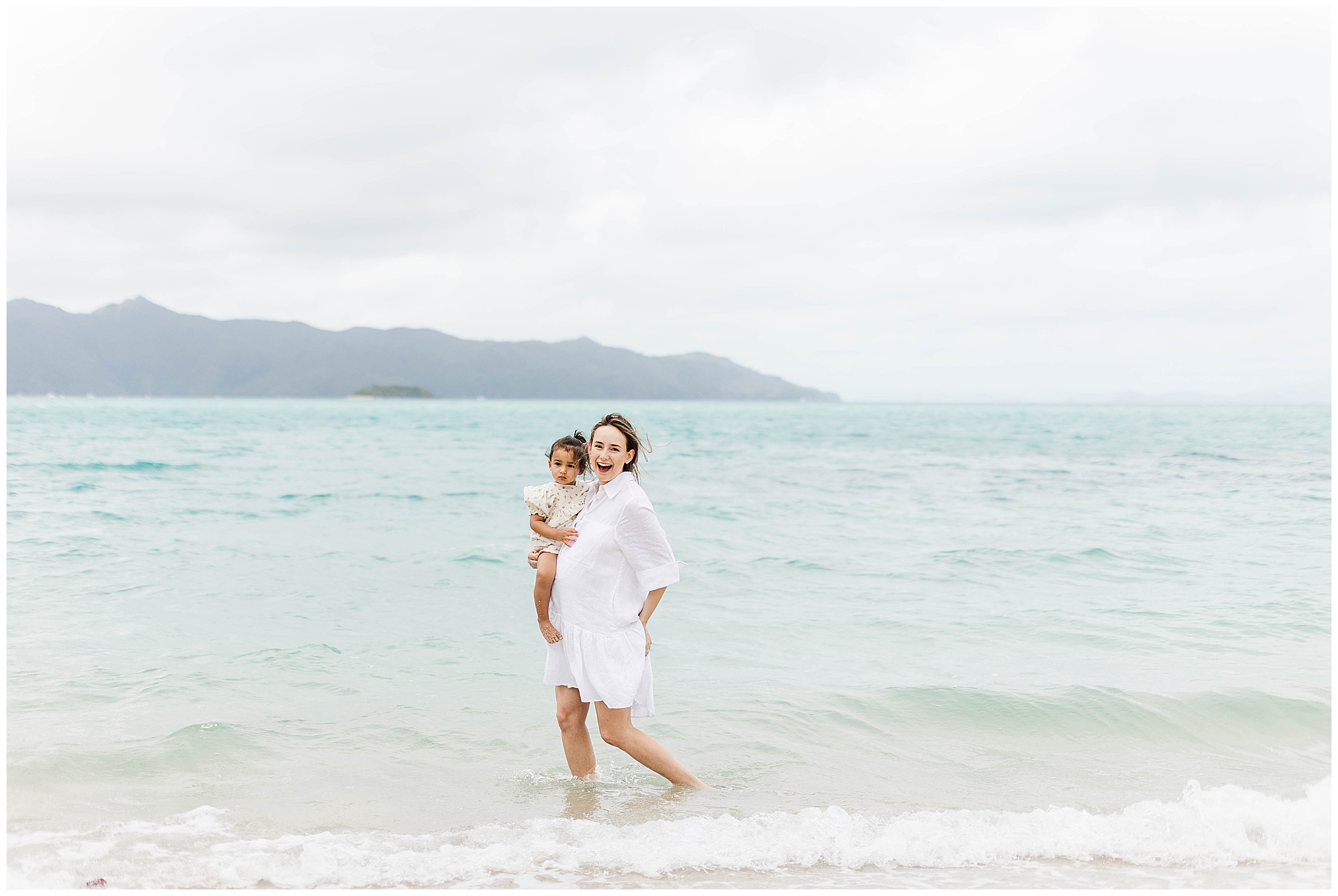 A Pregnant mum and her child having maternity photoshoot on Hayman Island by ALyce Holzy Photographer