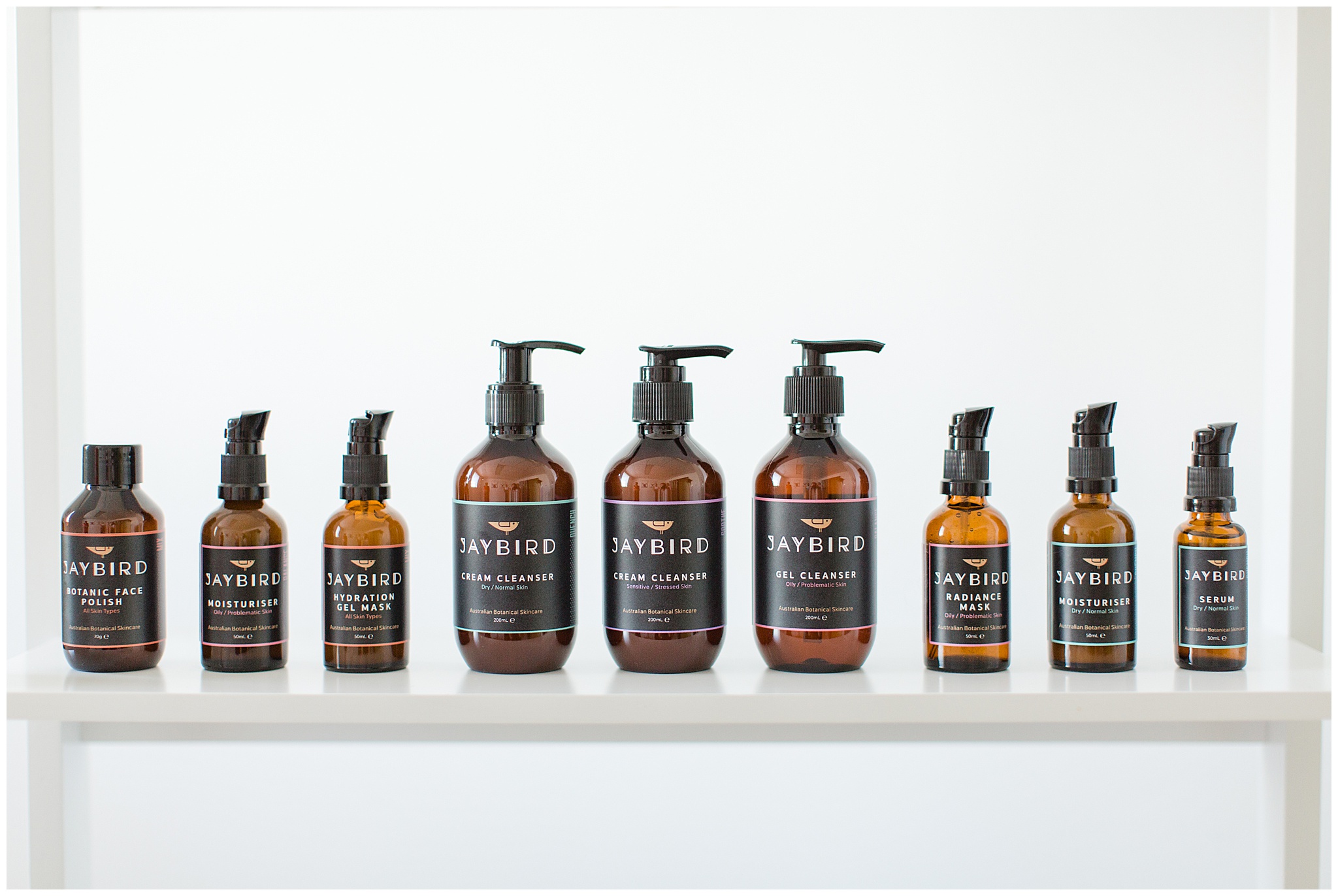 Light and bright product photography of botanical skincare jars on shelf in Mackay studio.