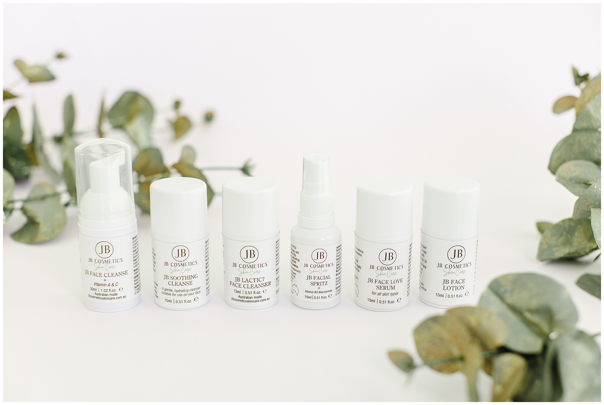 JB Skincare full product lineup styled on white backdrop with Baby Blue Eucalyptus, photographed in a Mackay studio for natural Australian skincare branding.